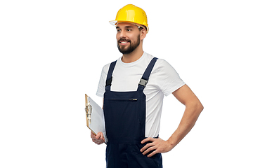 Image showing happy worker or builder in helmet with clipboard