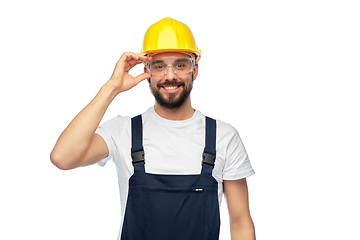 Image showing happy male worker or builder in helmet and overall