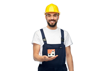 Image showing happy male builder holding model of living house