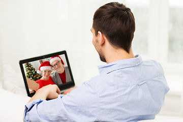 Image showing man having video call with family on christmas