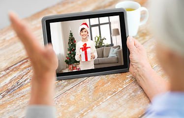 Image showing grandmother has video call with boy on christmas