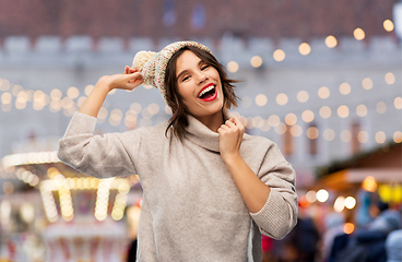 Image showing happy woman in hat and sweater at christmas market