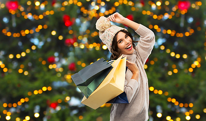 Image showing young woman in winter hat with shopping bags