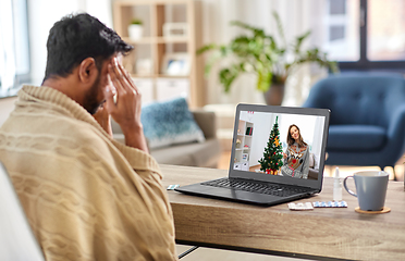 Image showing sick man having video call with woman on christmas