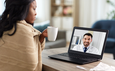 Image showing sick woman having video call with doctor on laptop