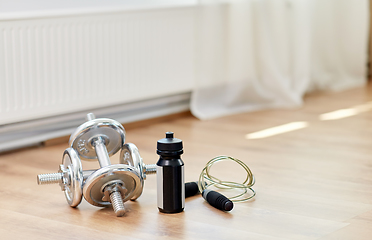 Image showing dumbbells, skipping rope and bottle on floor
