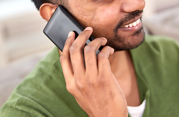 Image showing close up of happy indian man calling on smartphone