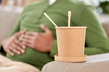 Image showing cup of takeaway food over man at home