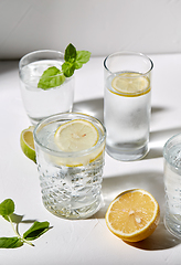 Image showing glasses with lemon water and peppermint on table