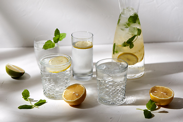 Image showing glasses with lemon water and peppermint on table