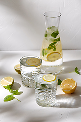 Image showing glasses with lemon water and peppermint on table