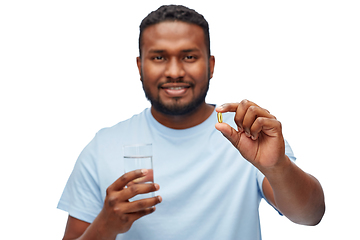 Image showing african american man with pill and glass of water