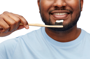 Image showing smiling african man with toothbrush cleaning teeth