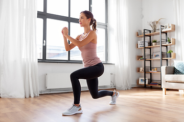 Image showing young woman exercising at home