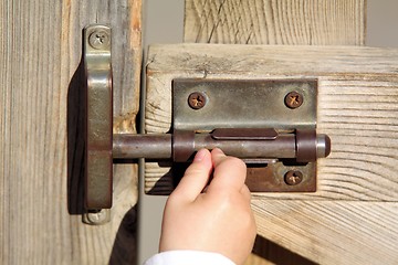 Image showing Baby opening a door