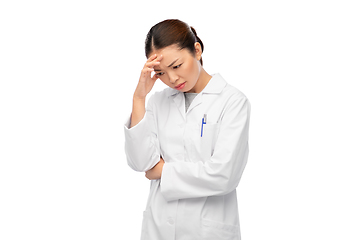 Image showing sad thinking asian female doctor in white coat