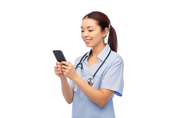 Image showing happy asian female doctor or nurse with smartphone