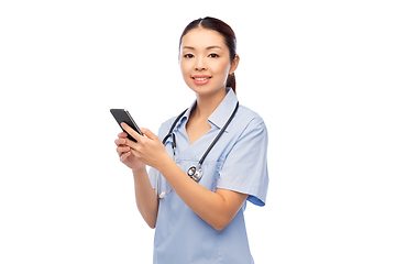 Image showing happy asian female doctor or nurse with smartphone