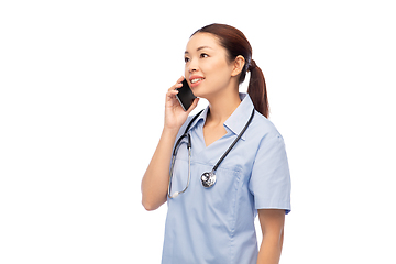 Image showing asian female doctor or nurse calling on smartphone