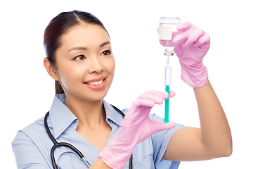 Image showing happy asian female nurse with medicine and syringe