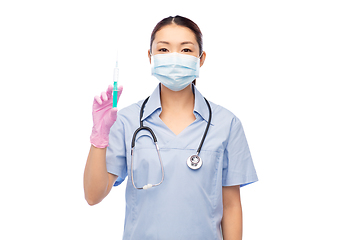 Image showing asian nurse in mask with medicine in syringe