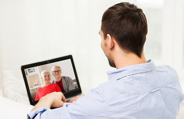 Image showing man with laptop having video call with his family