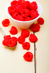 Image showing bunch of fresh raspberry on a bowl and white table