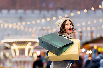 Image showing happy woman with shopping bags at christmas market