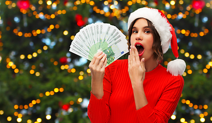 Image showing surprised woman with money on christmas