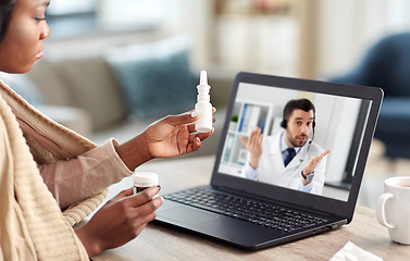 Image showing sick woman having video call with doctor on laptop