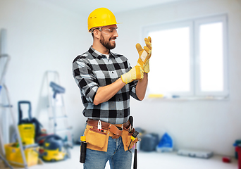 Image showing happy male worker or builder in helmet and gloves