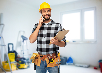 Image showing happy builder with clipboard calling on smartphone
