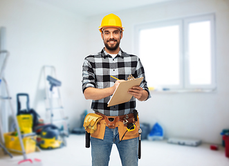 Image showing male worker or builder in helmet with clipboard