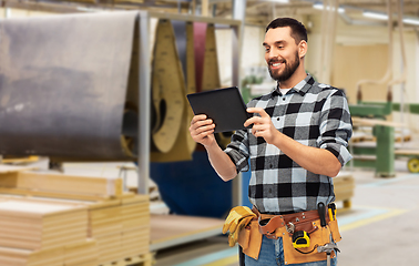 Image showing happy builder with tablet computer and tools