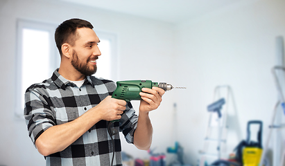 Image showing happy man, worker or builder with drill