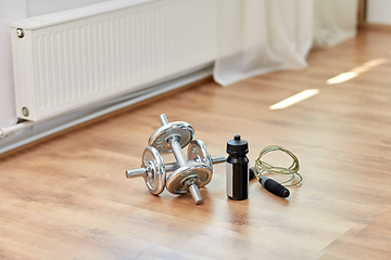 Image showing dumbbells, skipping rope and bottle on floor