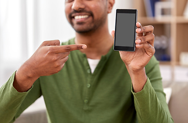 Image showing close up of smiling man showing smartphone at home