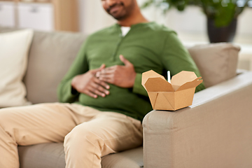 Image showing cup of takeaway food over man at home