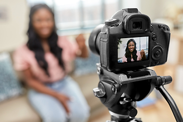 Image showing female blogger with camera video blogging at home