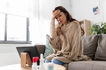 Image showing sick woman having video call on tablet pc at home