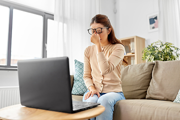 Image showing tired woman with laptop working at home office