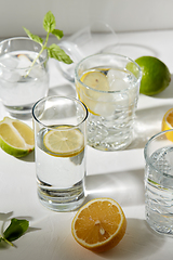 Image showing glasses with lemon water and peppermint on table