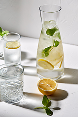 Image showing glasses with lemon water and peppermint on table