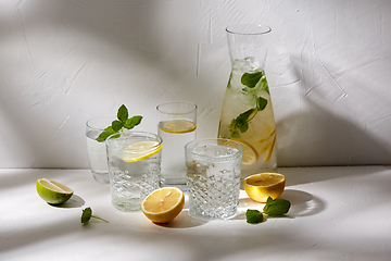 Image showing glasses with lemon water and peppermint on table