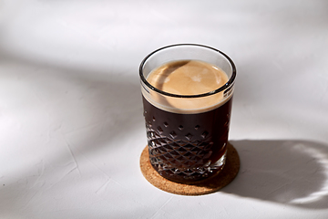 Image showing glass of coffee on cork drink coaster