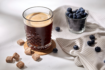 Image showing glass of coffee, brown sugar and blueberries