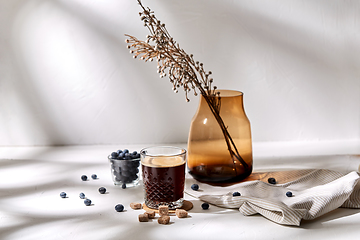 Image showing glass of coffee, brown sugar and blueberries