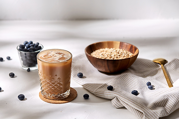 Image showing glass of ice coffee, oatmeal and blueberries