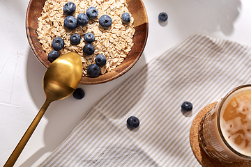 Image showing oatmeal with blueberries, spoon and coffee