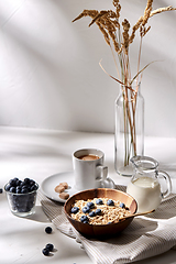 Image showing oatmeal with blueberries, milk and cup of coffee